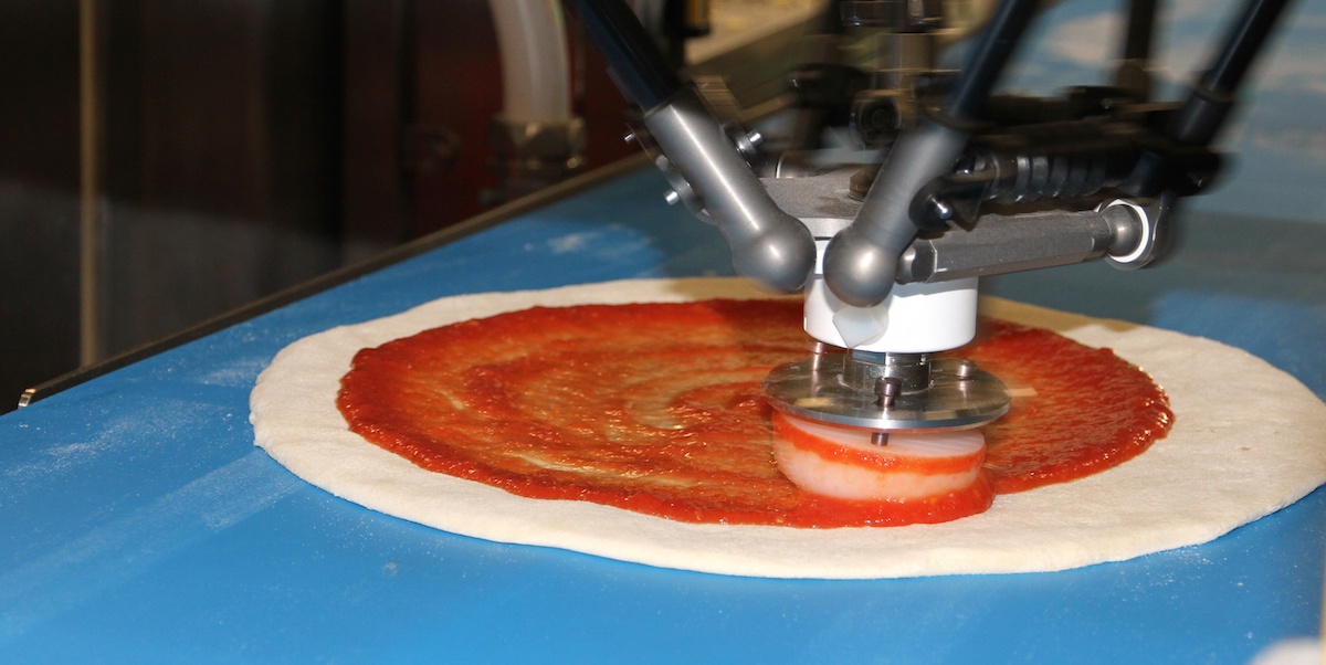 Marta, one of Zume Pizza's robots, ensures the perfect sauce to dough ratio.